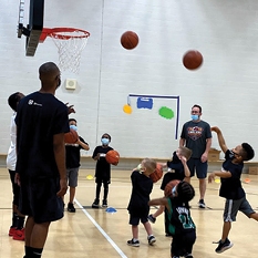 Cleveland Cavalittles playing basketball with kids.