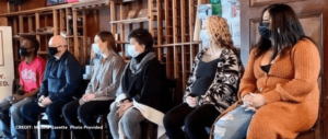 A group of people wearing masks during the COVID pandemic receiving addiction services