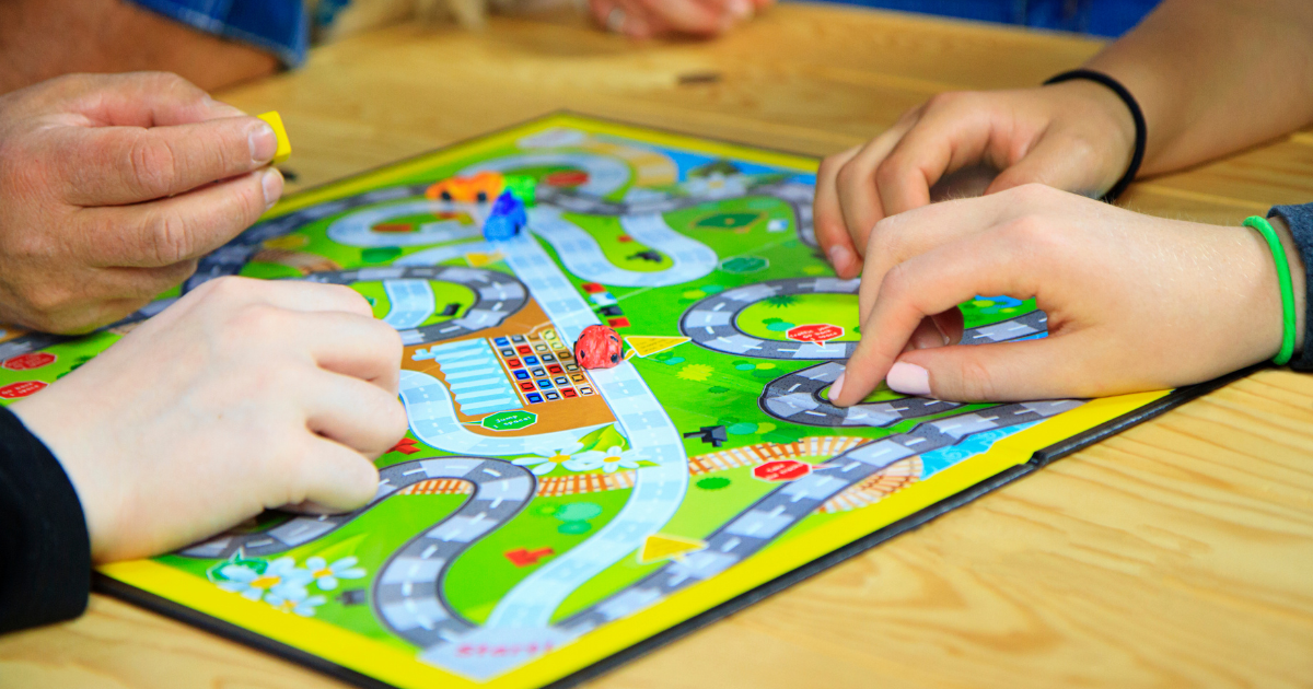4 Great Foster Family Game Night Ideas A board game during family game night is one way a foster family can connect with their foster child.